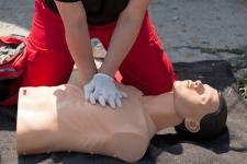 man practicing cpr on a dummy