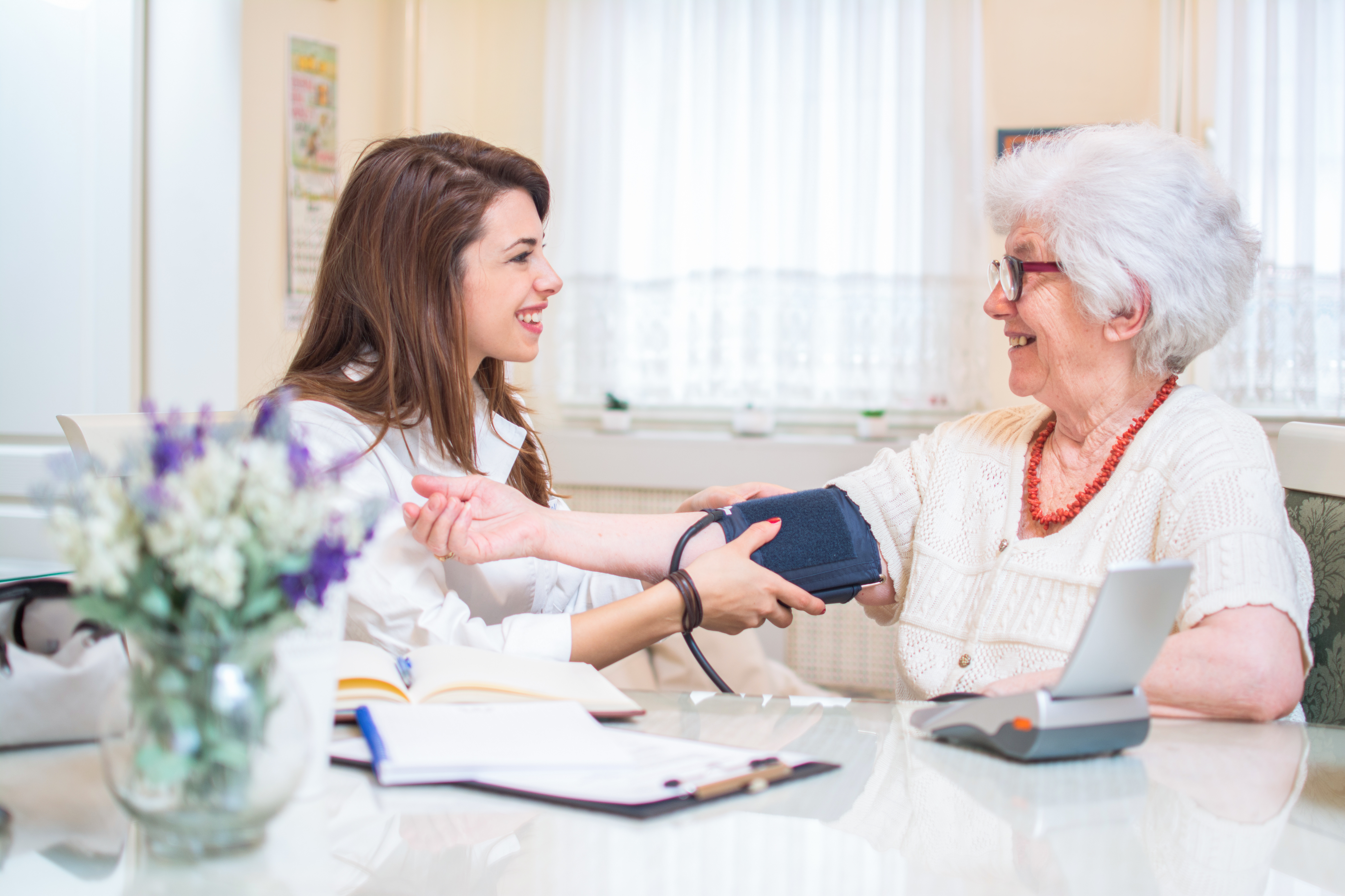 Doctor taking patients blood pressure 