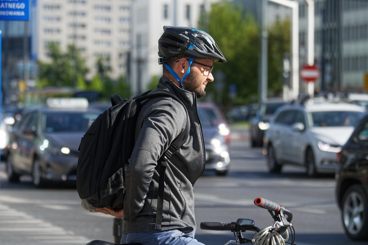 Man on bicycle near street traffic