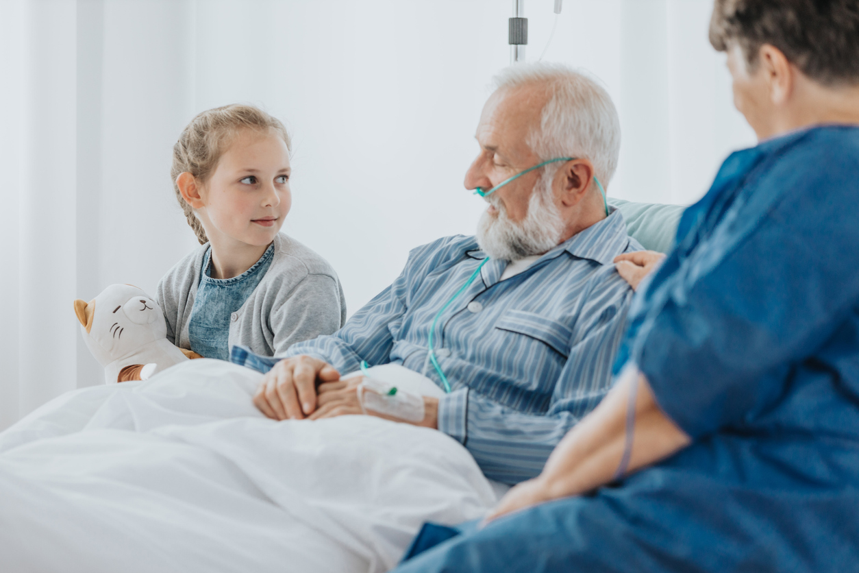 elderly man in bed with child next to him