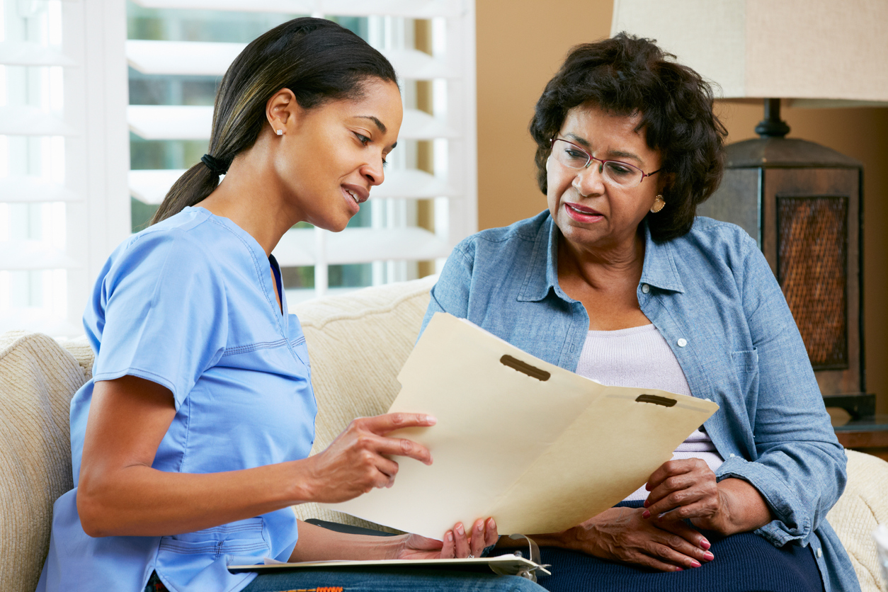 nurse talking to women on couch