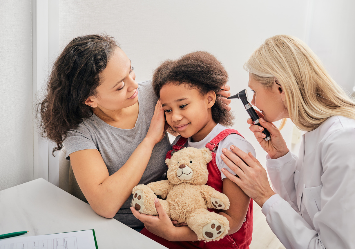 doctor looking into little girls ear