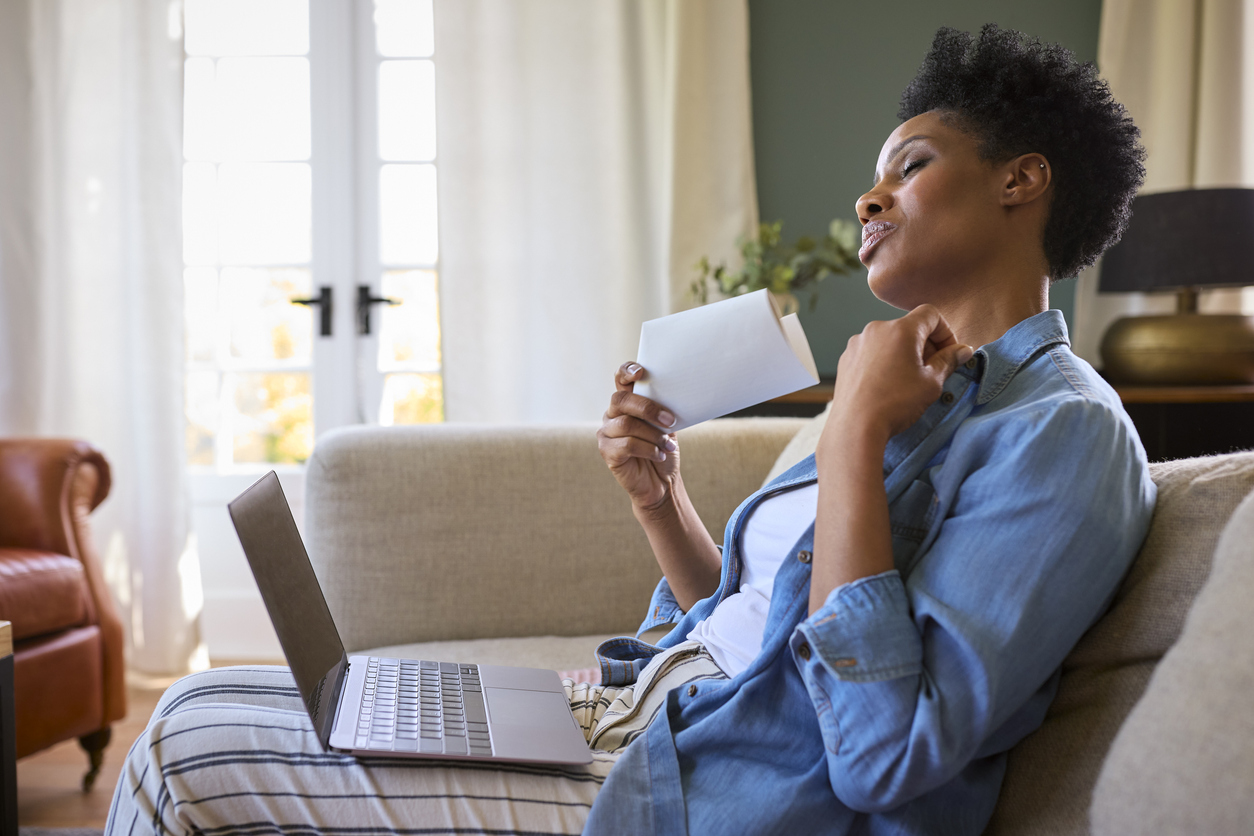 Woman fanning herself on the couch