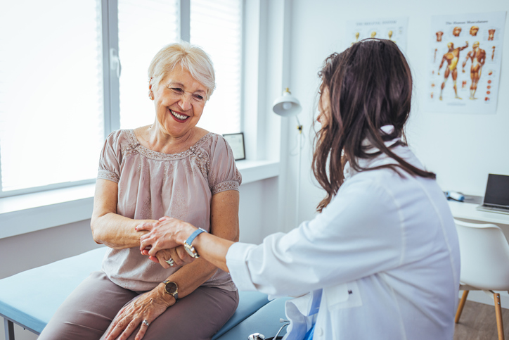 Hand of doctor reassuring her female patient