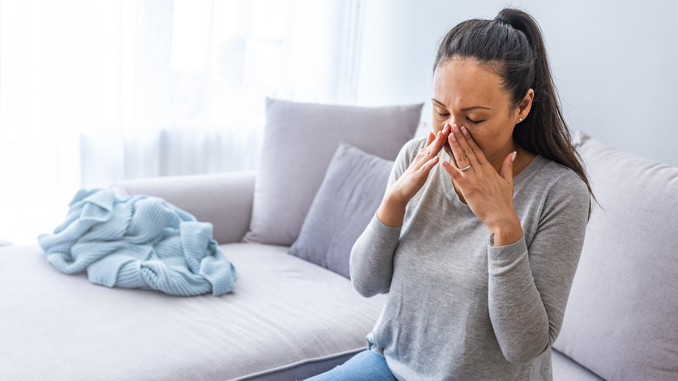 Woman experiencing sinus pressure