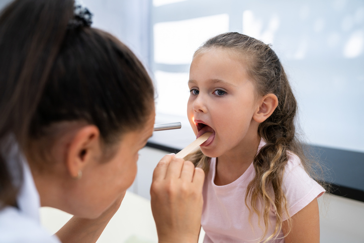 ENT examining young girl's throat