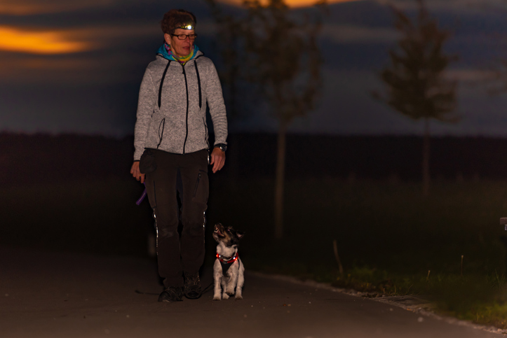 Woman walking at night with headlamp