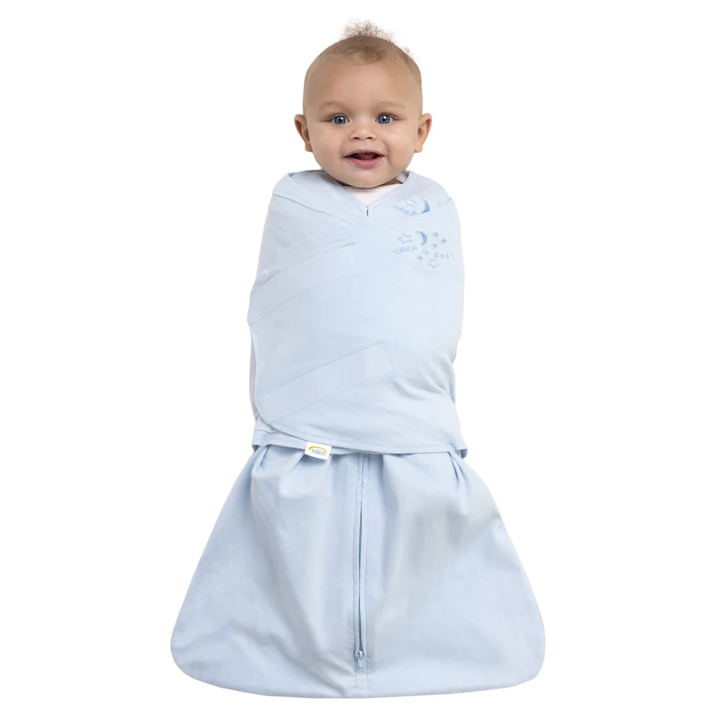 Smiling baby wrapped in light blue fabric swaddle
