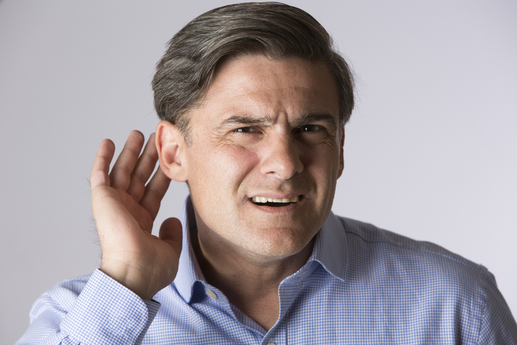 Man cupping his ear to hear