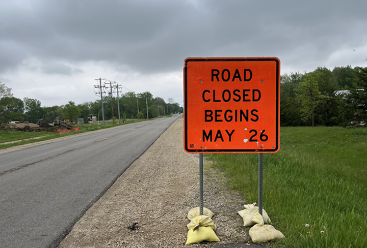 Road sign says "Road Closed starting May 26"
