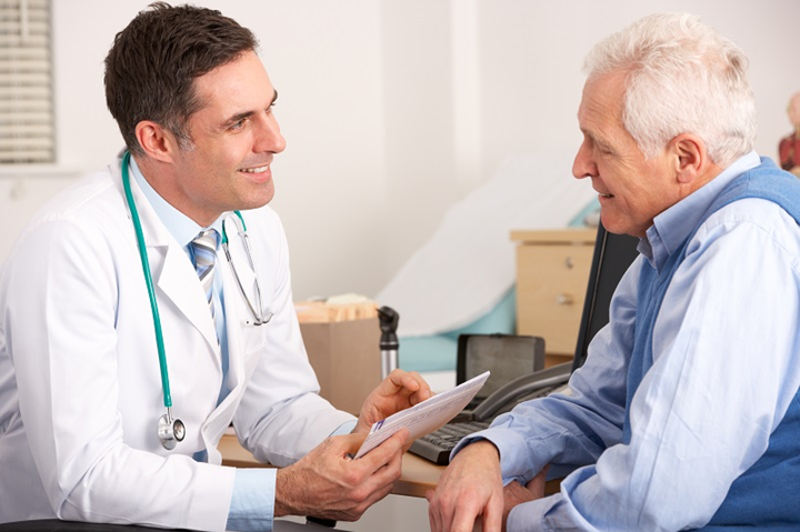 Older man speaks with doctor