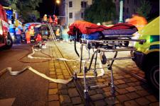 Patient being wheeled into ambulance at night