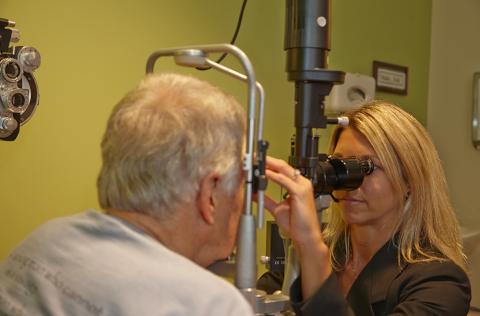 eye doctor examines a patient's eyes