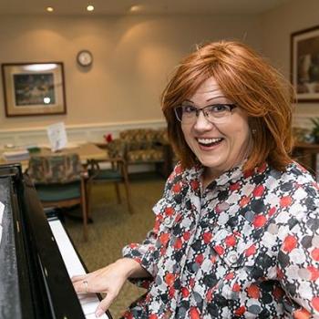 Kristi Craig playing the piano smiling